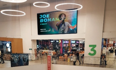 digital signage screen placed at a mall showing upcomig event post from brand's Instagram page using Pickcel software.