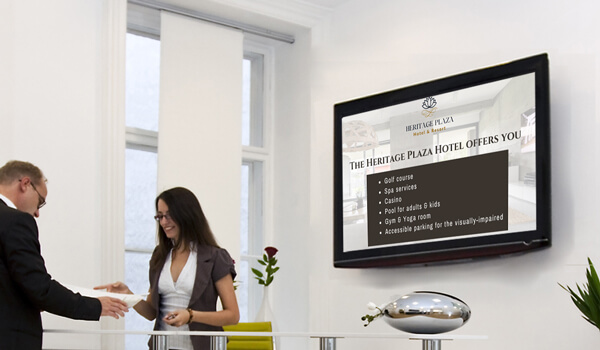 A hotel lobby screen shows off the hotel amenities on a wall-mounted digital signage