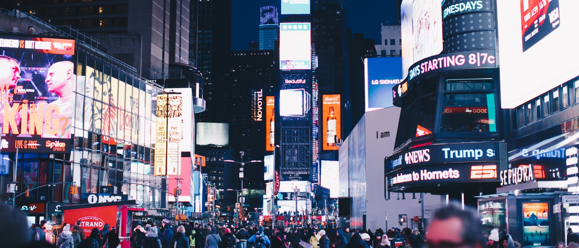 digital signage displays showing content in busy new york street