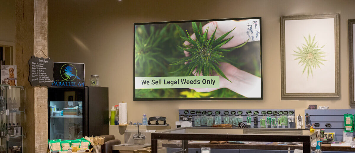 legal weed store equipped with digital signage showing message we sell legal weed only