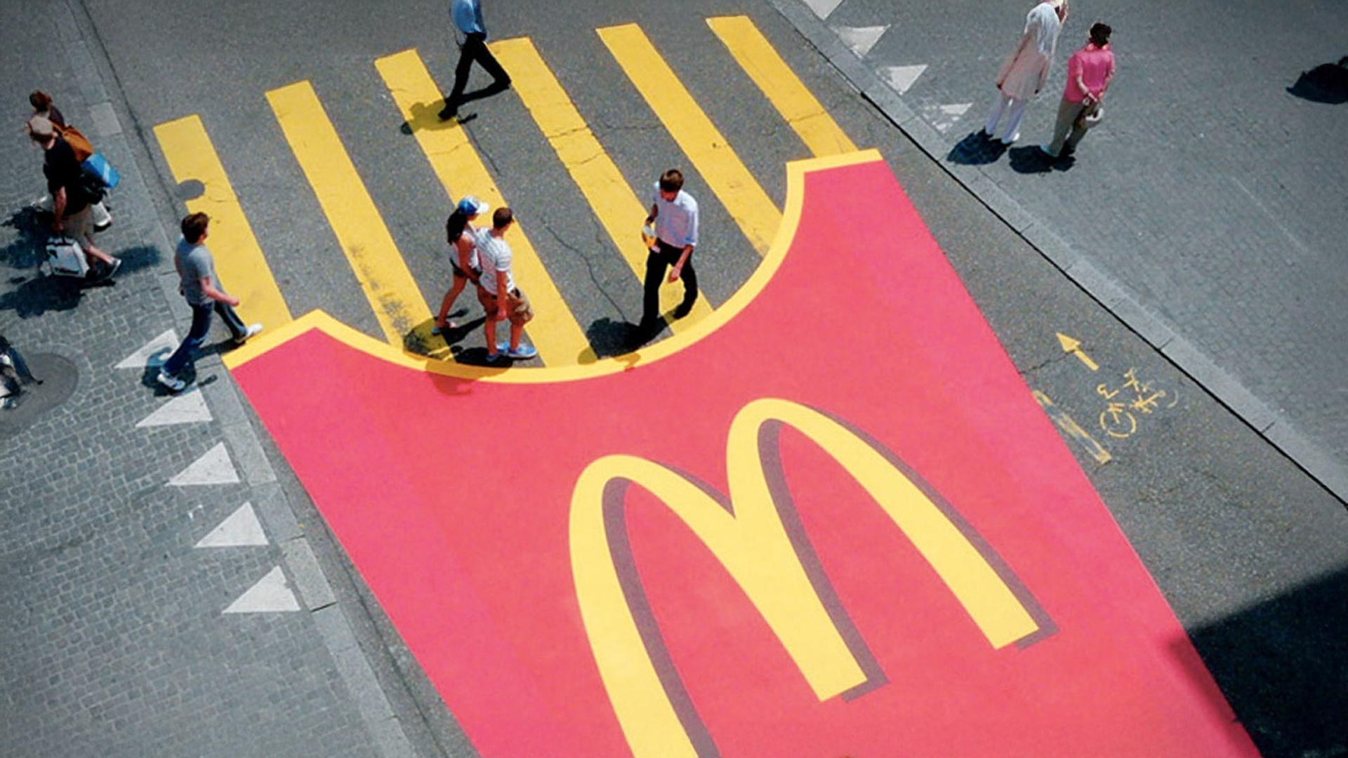 Image showing a cross walk painted as massive french fries box with Mcdonald's branding.