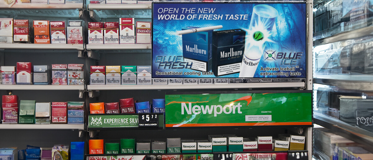 How is digital signage used in tobacco shops?