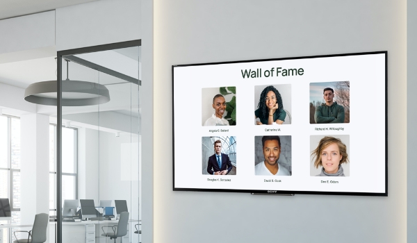 A digital employee recognition board displays the names & photos of star employees under the title: Wall Of Fame